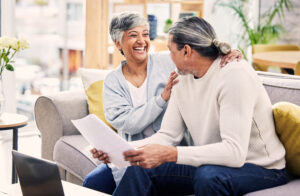 Financial, senior or happy couple laughing with documents in home for retirement savings or pension.