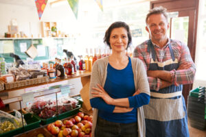 Portrait Of Mature Couple Running Organic Farm Shop Together