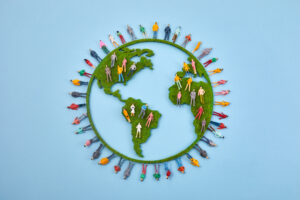 World Population Day, creative concept. Large and diverse group of people in the shape of the world map.